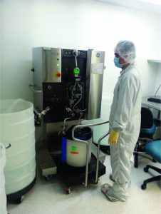 Photo 2: A 30-cm Repligen OPUS column containing CaptivA resin connected to an ÄKTA Ready skid (GE Healthcare) during a wash cycle for a GMP manufacturing operation 