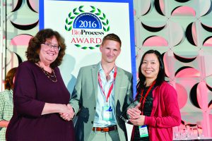 Oliver Hardick (Puridify) and Cindy Jung (GlaxoSmithKline) accept the Best Collaboration award from BPI’s Anne Montgomery.