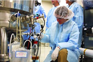 Photo 1: A participant samples a 300-L bioreactor in BTEC’s large-scale area.