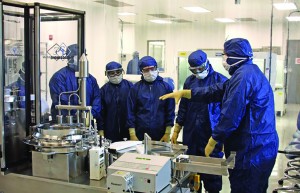 Photo 4: Students learn about the semiautomated filling machines in the Aseptic Processing course.